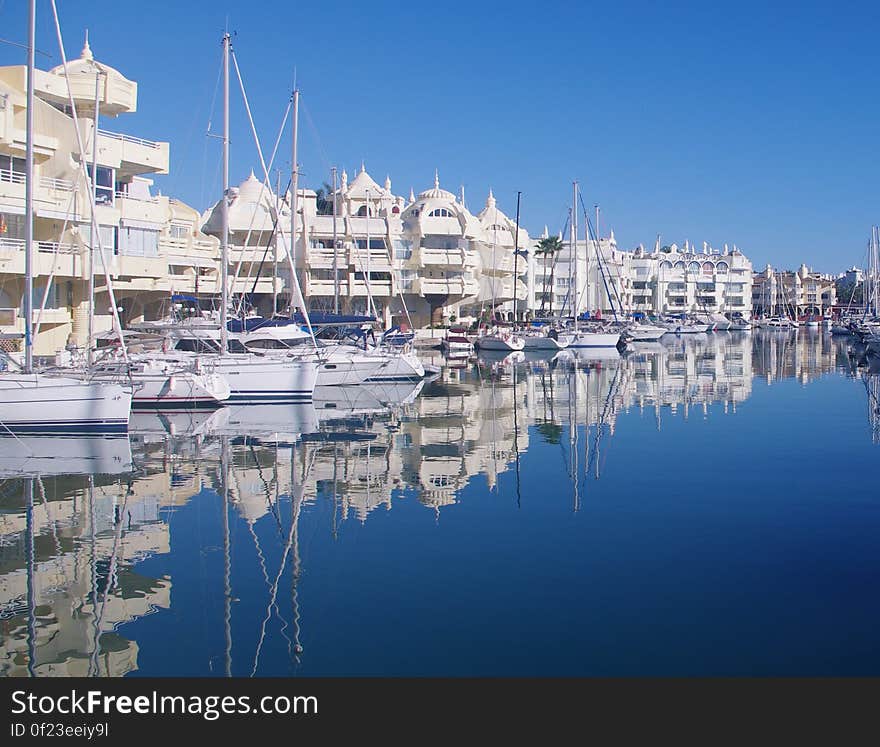 Boats in a harbor with blue still waters. Boats in a harbor with blue still waters.