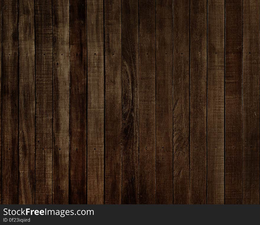 A dark wood board background. A dark wood board background.