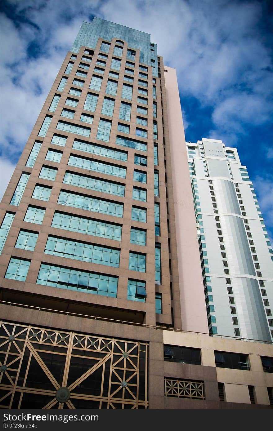 Brown and White Concrete Building Under White and Blue Cloudy Sky