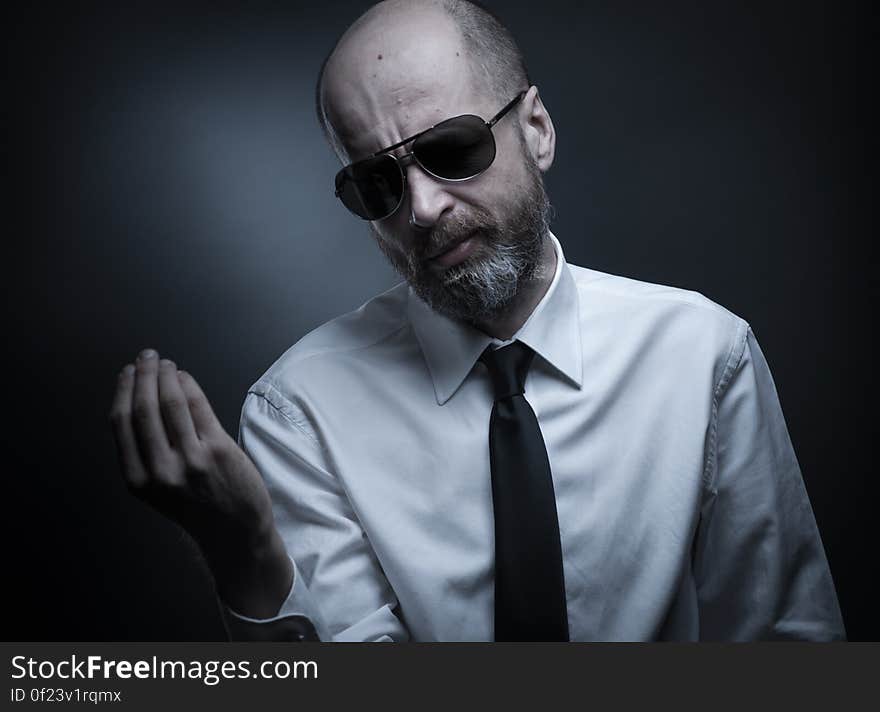 A man with white shirt, tie and sunglasses. A man with white shirt, tie and sunglasses.