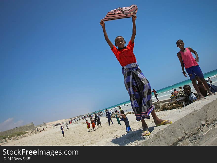 A Somali boy holds a shirt aloft to dry in the wind at Lido Beach in the Abdul-Aziz district of the Somali capital Mogadishu 09 November 2012. Lido Beach has become a popular spot on Friday&#x27;s with hundreds of Somalis since the withdrawal in August 2011 of the Al-Qaeda affiliated extremist group Al Shabaab who had banned any such social gatherings between men and women. The United Nations Security Council on November 7 renewed the mandate of the African Union Mission in Somalia &#x28;AMISOM&#x29; peacekeeping force for a further four months to continue providing support to the Government of Somalia in its efforts to bring peace and stability to the Horn of African country. AU-UN IST PHOTO / STUART PRICE. A Somali boy holds a shirt aloft to dry in the wind at Lido Beach in the Abdul-Aziz district of the Somali capital Mogadishu 09 November 2012. Lido Beach has become a popular spot on Friday&#x27;s with hundreds of Somalis since the withdrawal in August 2011 of the Al-Qaeda affiliated extremist group Al Shabaab who had banned any such social gatherings between men and women. The United Nations Security Council on November 7 renewed the mandate of the African Union Mission in Somalia &#x28;AMISOM&#x29; peacekeeping force for a further four months to continue providing support to the Government of Somalia in its efforts to bring peace and stability to the Horn of African country. AU-UN IST PHOTO / STUART PRICE.