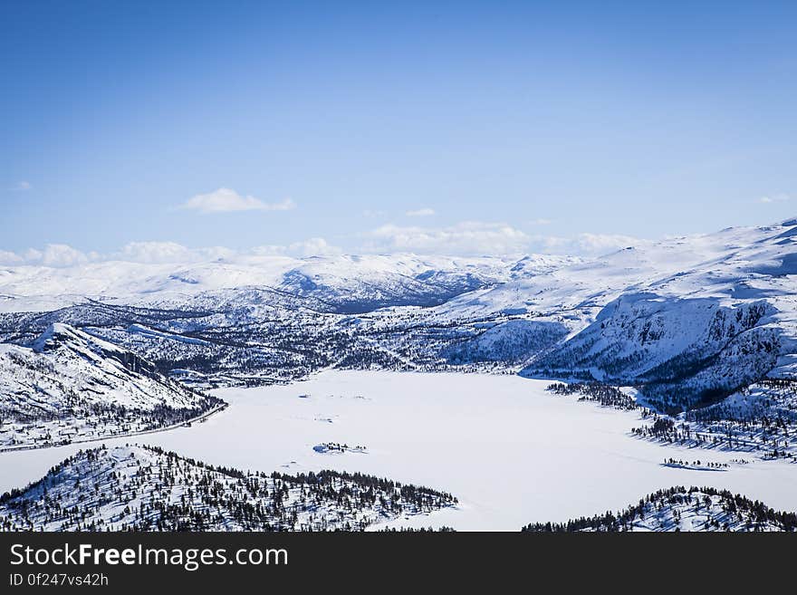 A panoramic view of a mountain valley covered in snow. A panoramic view of a mountain valley covered in snow.