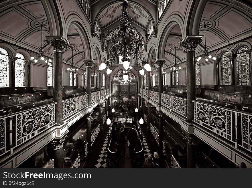 Grayscale Photo of Chandelier over Black Table