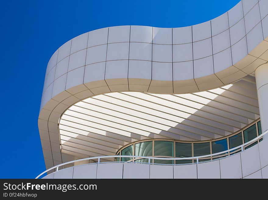 A close up of a building with curved wall and balcony. A close up of a building with curved wall and balcony.