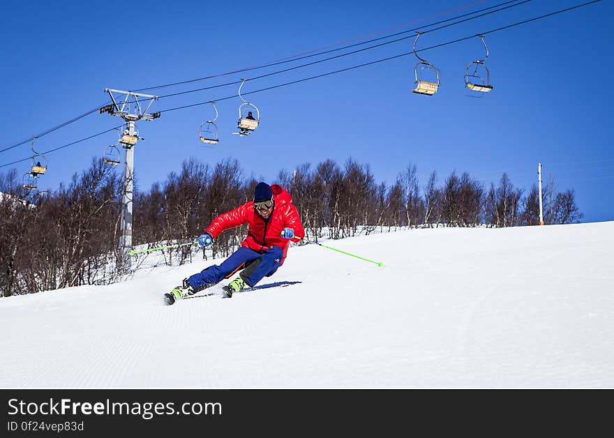 A skier at ski resort downhill skiing.