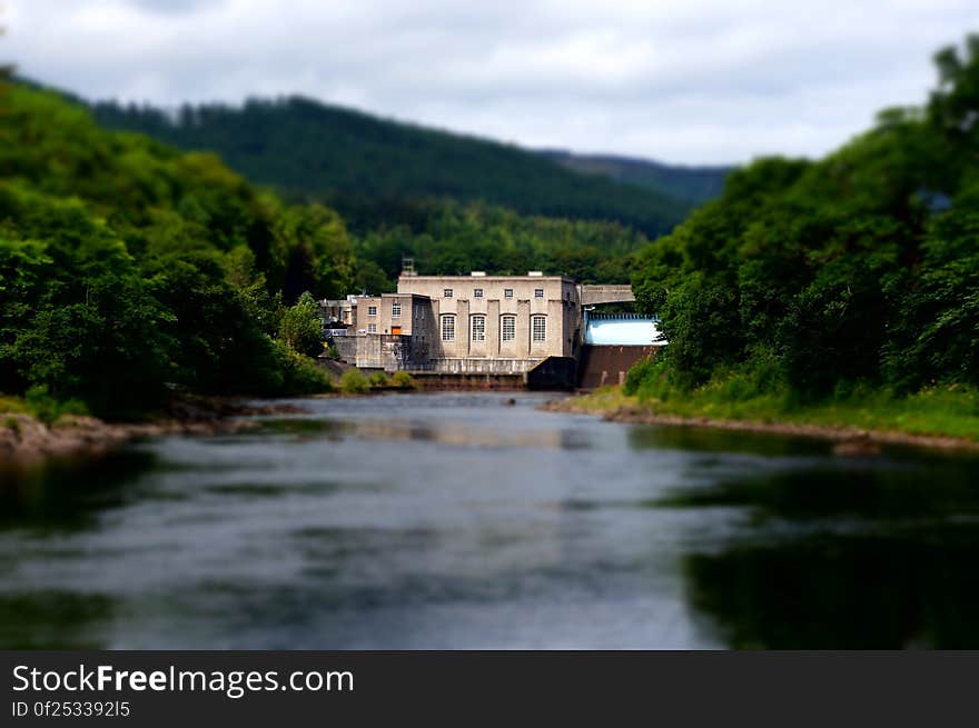 Beige House in on a Forest With River in Front