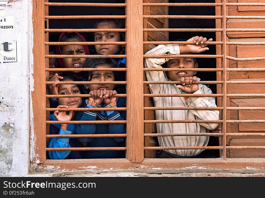 5 People Leaning on Brown Railings of Window