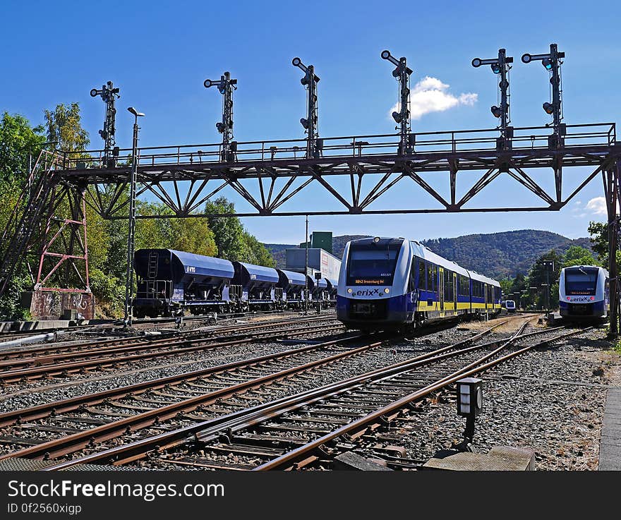 A view of a train yard with trains on the tracks.