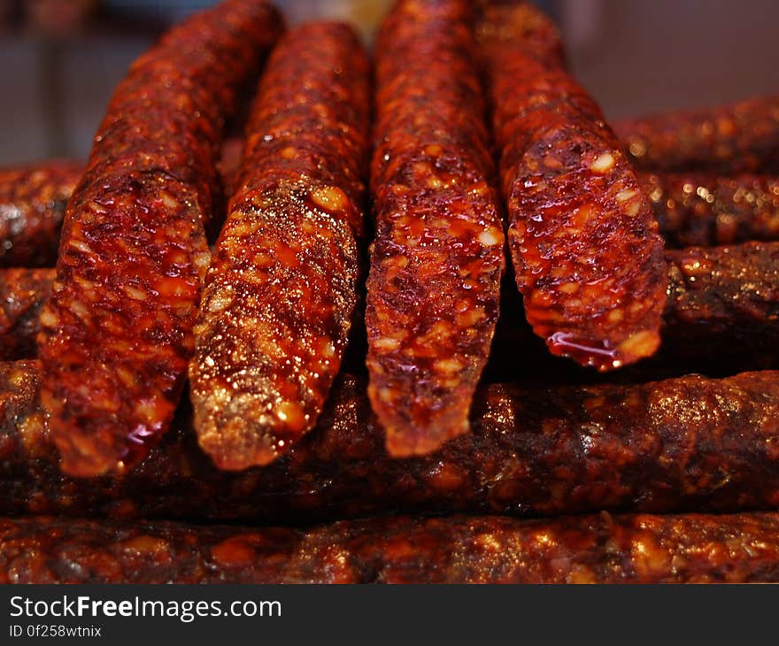 A stack of spicy cured sausages at grill. A stack of spicy cured sausages at grill.