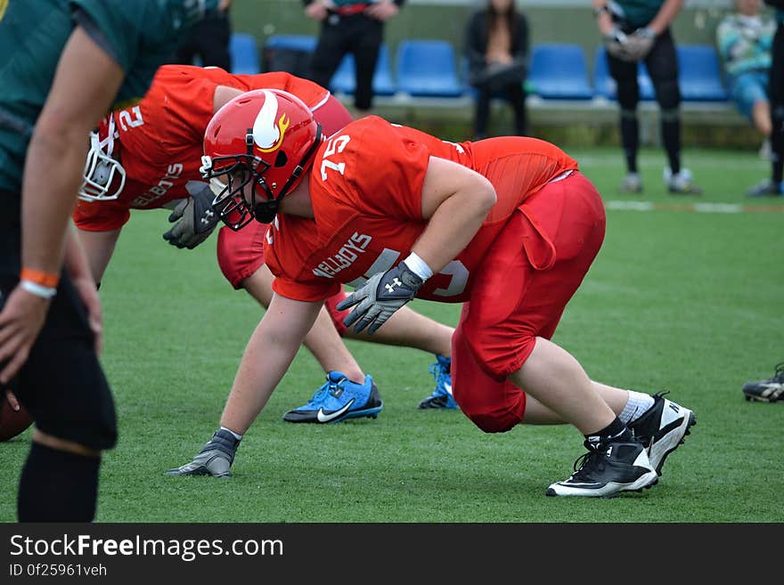 American football players on field during the snap.