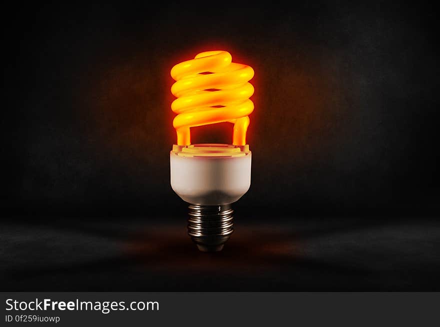 A close up of a glowing energy saving light bulb.