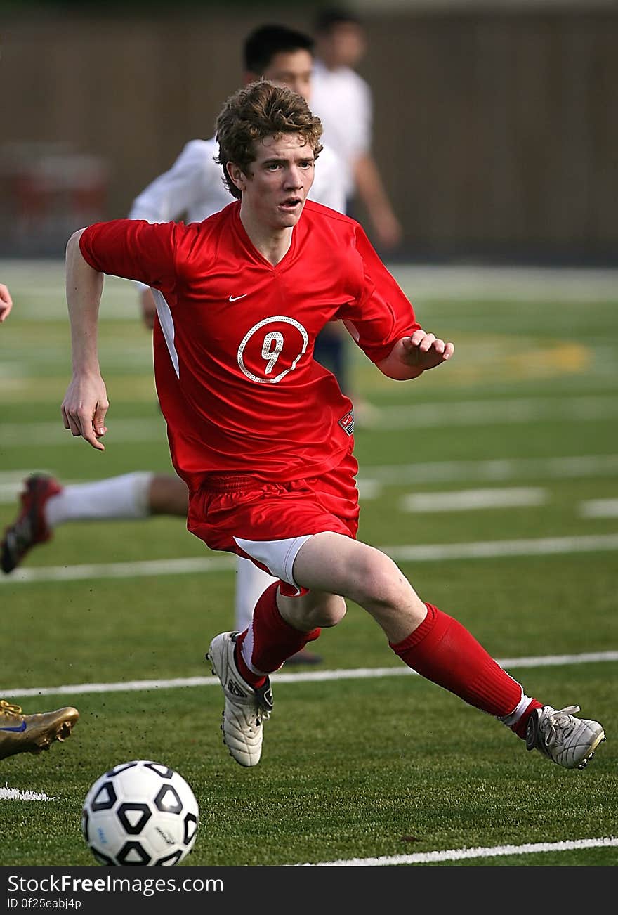 Man in Red Nike Jersey Shirt Playing Soccer