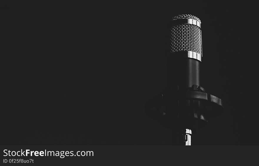 A microphone on a black background. A microphone on a black background.