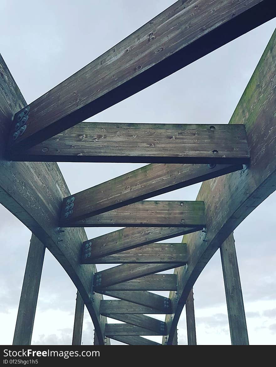 A wood structure against blue skies.