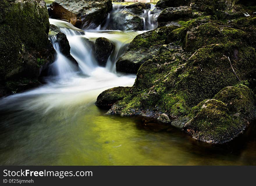 Water Fall Near Rock during Day Time