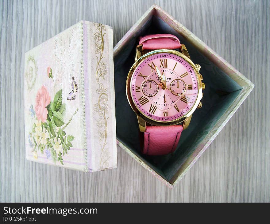 Overhead view of analogue ladies wristwatch in opened gift, box. Overhead view of analogue ladies wristwatch in opened gift, box.