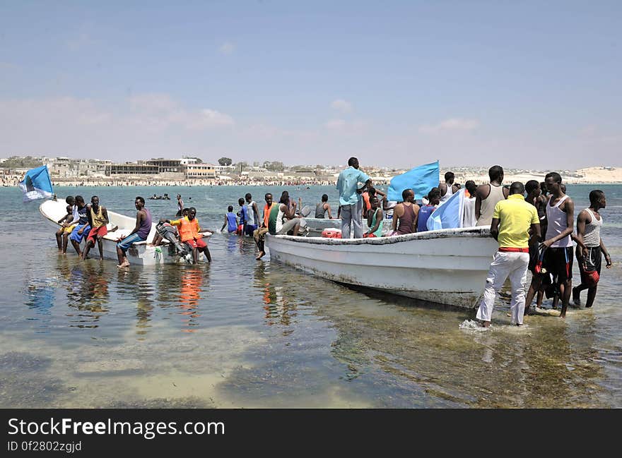 Residents of Mogadishu stand around Lido beache&#x27;s lifeboats on a sandbank in Somalia on January 31. The Mogadishu lifeguards, consisting entirely of a volunteer force of fisherman, began patrolling Lido beach in September 2013 after a spate of drownings. Mogadishu&#x27;s beaches have become a popular destination for the city&#x27;s residents since al Shabab withdrew the majority of its militants from the city in 2011. AU UN IST PHOTO / Tobin Jones. Residents of Mogadishu stand around Lido beache&#x27;s lifeboats on a sandbank in Somalia on January 31. The Mogadishu lifeguards, consisting entirely of a volunteer force of fisherman, began patrolling Lido beach in September 2013 after a spate of drownings. Mogadishu&#x27;s beaches have become a popular destination for the city&#x27;s residents since al Shabab withdrew the majority of its militants from the city in 2011. AU UN IST PHOTO / Tobin Jones