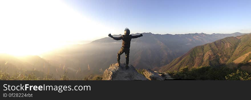 Panorama of mountaineer on mountain summit on sunny day. Panorama of mountaineer on mountain summit on sunny day.