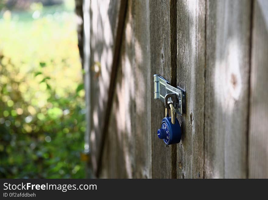 A house with untreated wood walls and a door locked with a combination lock. A house with untreated wood walls and a door locked with a combination lock.