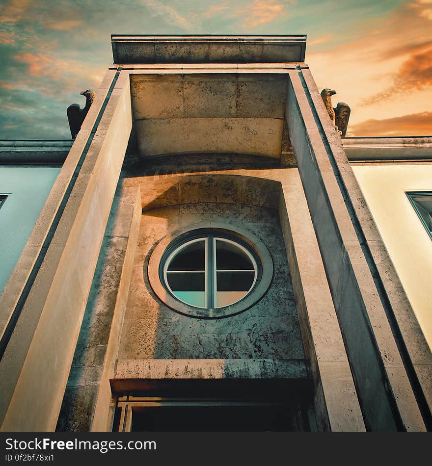 A round window in stone on a historic building. A round window in stone on a historic building.