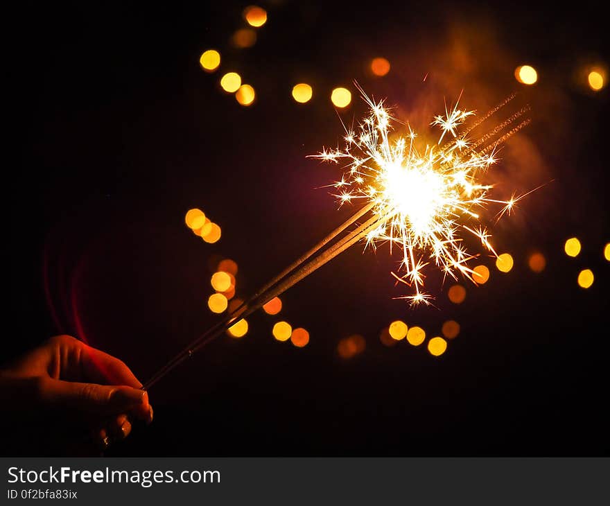 A close up of a person's hand holding a sprinkler.