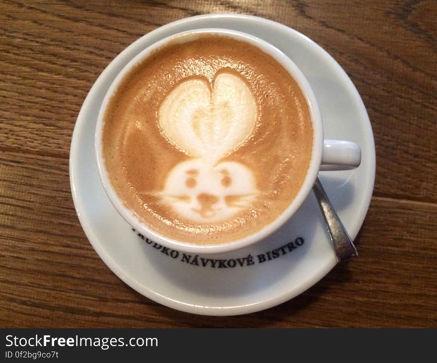 A cup of cappuccino with latte art of a bunny rabbit. A cup of cappuccino with latte art of a bunny rabbit.