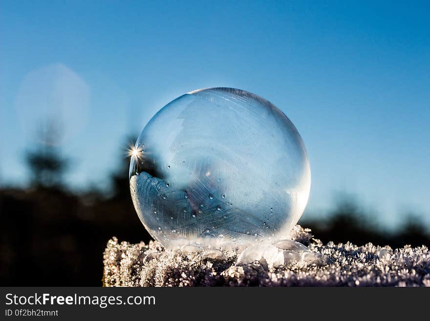 A frozen soap bubble out in the snow.