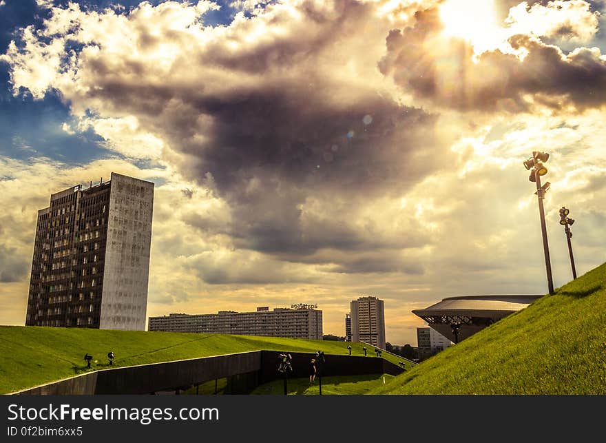 Green Grass Land Under Blue and White Cloudy Sky during Day Time