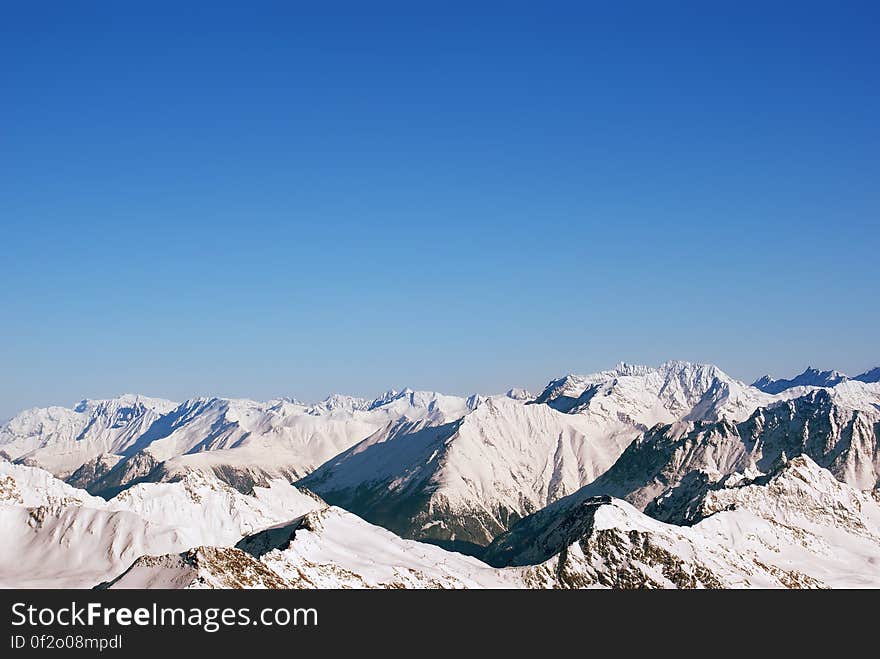 Landscape of snow-capped mountain peaks in the Alps, and a lot of air cleanliness