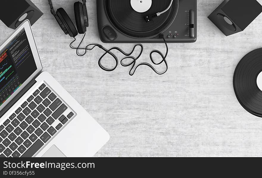 Macbook Pro Beside Black Headphones on Gray Table