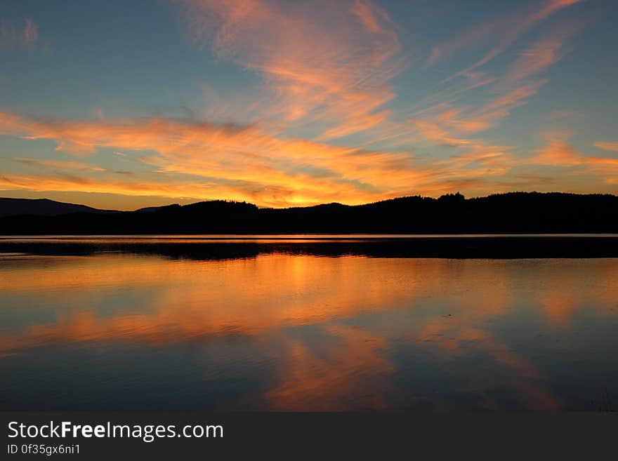 Lake Near the Mountains Under the Blue Sky