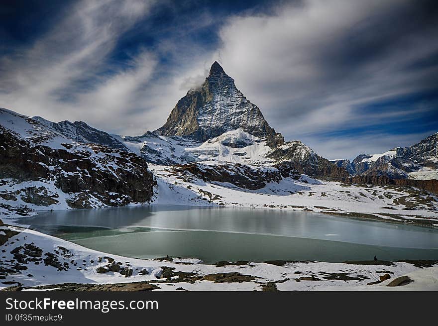 Alpine lake with snow covered peaks of Alps in Zermatt, Switzerland. Alpine lake with snow covered peaks of Alps in Zermatt, Switzerland.