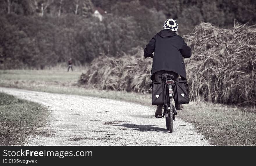 A bicyclist on a gravel road. A bicyclist on a gravel road.