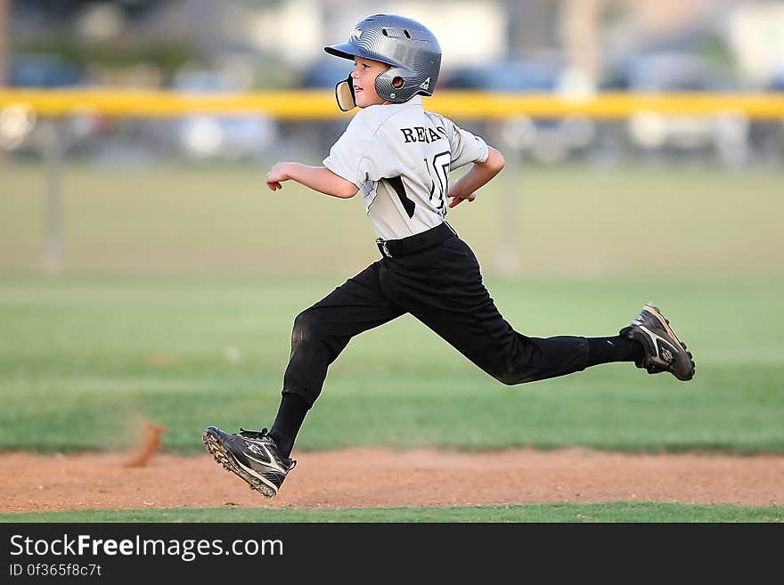 Baseball Player in Gray and Black Uniform Running