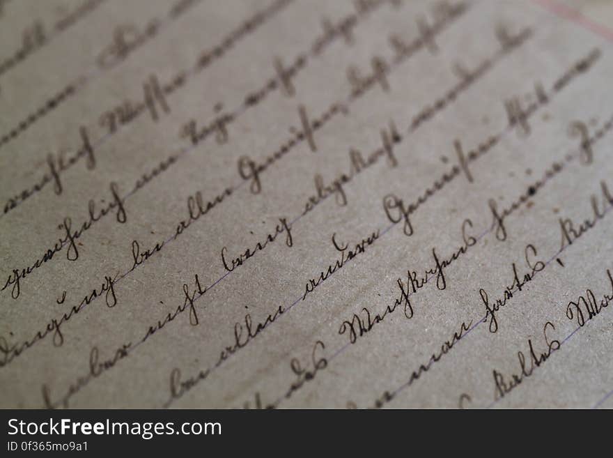 Close up of cursive script in black ink on antique paper. Close up of cursive script in black ink on antique paper.