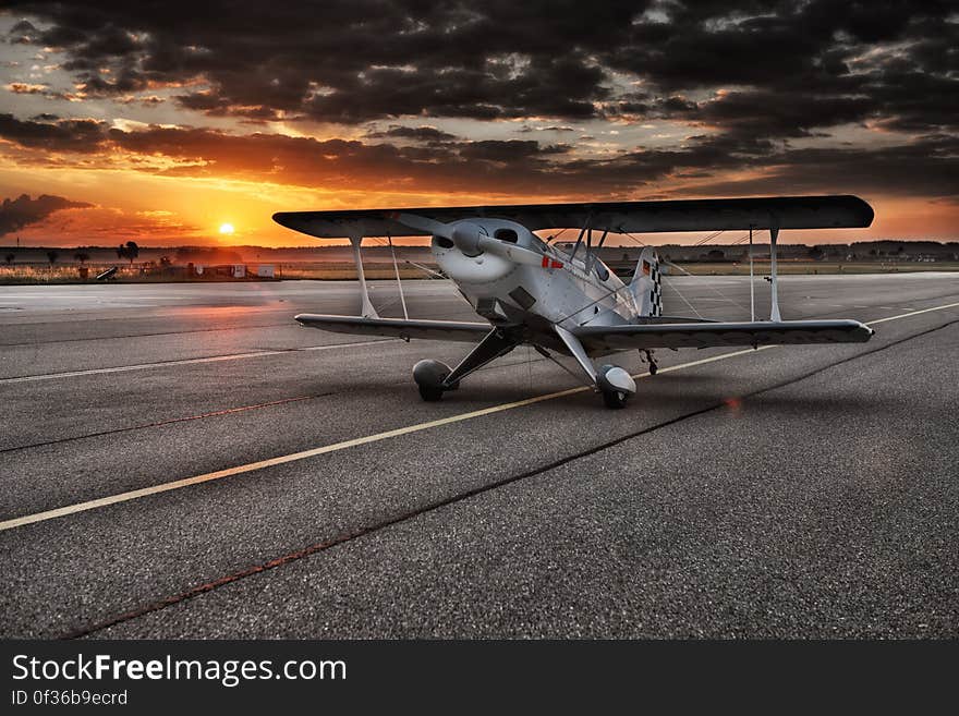 Black and White Aviation Plane Arriving during Sunset