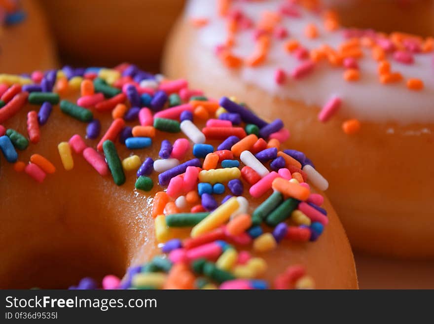 Close up of donuts with colorful sprinkles on them. Close up of donuts with colorful sprinkles on them.