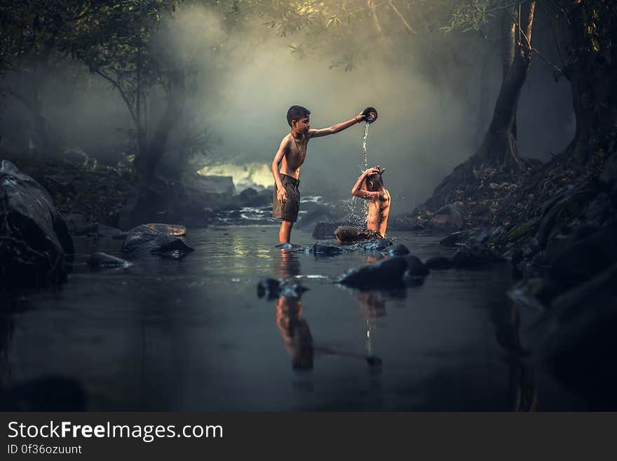 A pair of boys washing in the river. A pair of boys washing in the river.