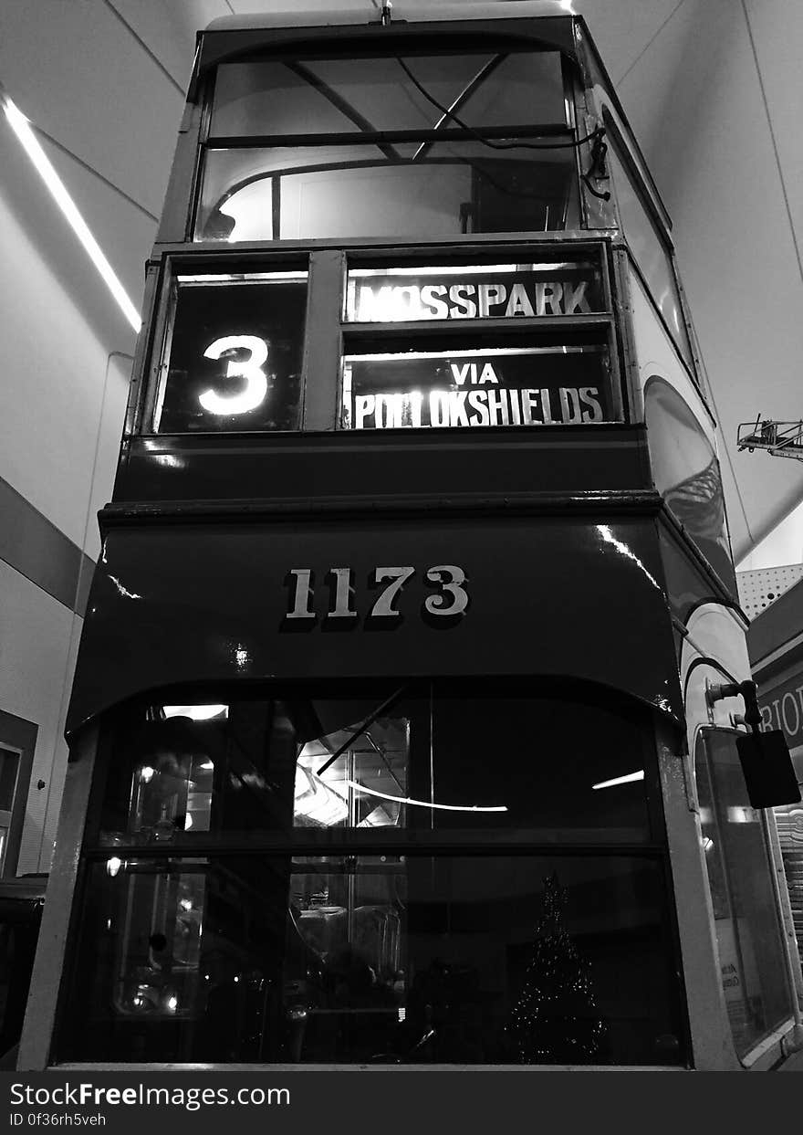 Rear of double deck bus inside terminal in black and white. Rear of double deck bus inside terminal in black and white.