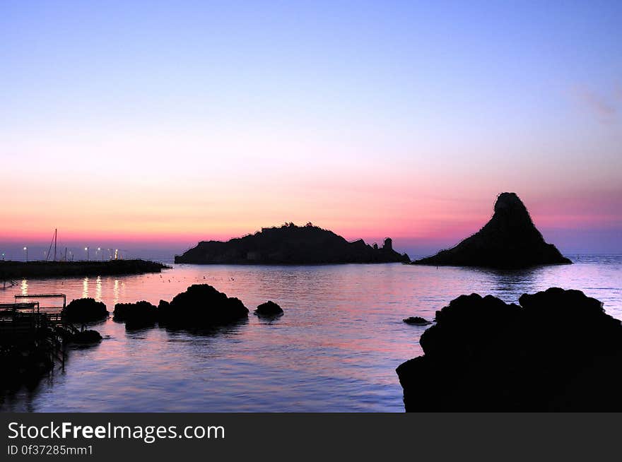 See more ... www.flickr.com/photos/gnuckx The Islands of the Cyclops Of the coast of Aci Trezza are three tall, column-shaped islands. According to local legend, these great stones are the ones thrown at Odysseus in The Odyssey. The islands are referred to as the &quot;isole dei ciclopi&quot; &#x28;islands of the Cyclops, or Cyclopean Isles&#x29; by locals. This compliments the notion that the Cyclops once had a smithy below Mount Etna, which looms over the village to the northwest. Aci Trezza is a town in Sicily, southern Italy, a frazione of the comune of Aci Castello, c. 10 km north of Catania, with a population of around 5,000 people. Located on the coast of the Ionian Sea, the village has a long history of maritime activity. Aci Trezza is a popular spot for Italian vacationers in the summer. The patron Saint of the town is St. John the Baptist. The Festa of San Giovanni is celebrated each year during the last week of June 24 in his honor. Le Isole dei Ciclopi Il panorama di Aci Trezza è dominato dai faraglioni dei Ciclopi: otto pittoreschi scogli basaltici che, secondo la leggenda, furono lanciati da Polifemo ad Ulisse durante la sua fuga. I faraglioni compaiono sugli stemmi dei comuni di Aci Castello, Acireale, Aci Bonaccorsi, Aci Catena. Poco distante dalla costa &#x28;a circa 400 m di distanza&#x29;, è presente l&#x27;Isola Lachea, identificata con l&#x27;omerica Isola delle Capre e che attualmente ospita la sede di una stazione di studi di biologia dell&#x27;Università degli Studi di Catania. See more ... www.flickr.com/photos/gnuckx The Islands of the Cyclops Of the coast of Aci Trezza are three tall, column-shaped islands. According to local legend, these great stones are the ones thrown at Odysseus in The Odyssey. The islands are referred to as the &quot;isole dei ciclopi&quot; &#x28;islands of the Cyclops, or Cyclopean Isles&#x29; by locals. This compliments the notion that the Cyclops once had a smithy below Mount Etna, which looms over the village to the northwest. Aci Trezza is a town in Sicily, southern Italy, a frazione of the comune of Aci Castello, c. 10 km north of Catania, with a population of around 5,000 people. Located on the coast of the Ionian Sea, the village has a long history of maritime activity. Aci Trezza is a popular spot for Italian vacationers in the summer. The patron Saint of the town is St. John the Baptist. The Festa of San Giovanni is celebrated each year during the last week of June 24 in his honor. Le Isole dei Ciclopi Il panorama di Aci Trezza è dominato dai faraglioni dei Ciclopi: otto pittoreschi scogli basaltici che, secondo la leggenda, furono lanciati da Polifemo ad Ulisse durante la sua fuga. I faraglioni compaiono sugli stemmi dei comuni di Aci Castello, Acireale, Aci Bonaccorsi, Aci Catena. Poco distante dalla costa &#x28;a circa 400 m di distanza&#x29;, è presente l&#x27;Isola Lachea, identificata con l&#x27;omerica Isola delle Capre e che attualmente ospita la sede di una stazione di studi di biologia dell&#x27;Università degli Studi di Catania.