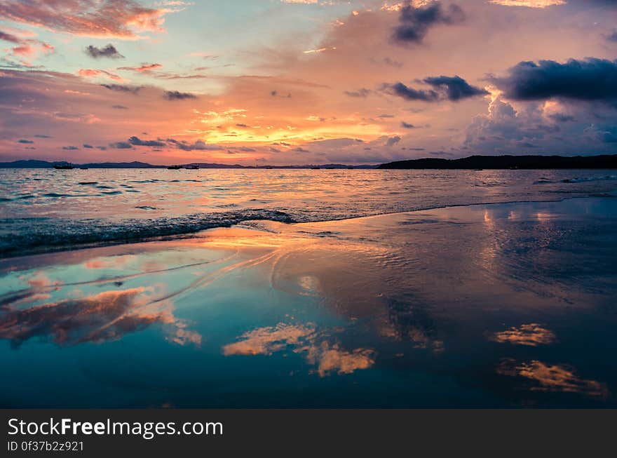 View from the beach at sunset at the sea. View from the beach at sunset at the sea.