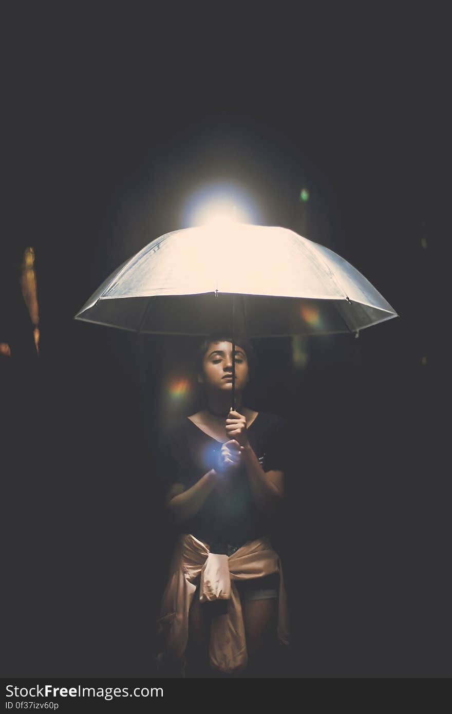 Woman Holding Illuminated Lamp at Night