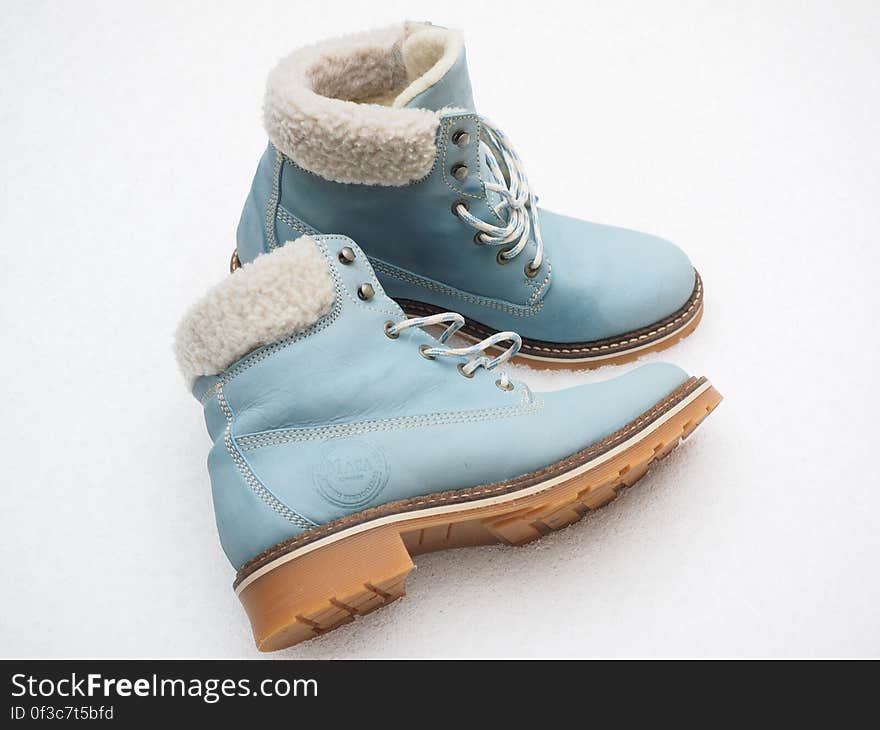 Close up of blue leather winter fleece lined boots on white. Close up of blue leather winter fleece lined boots on white.