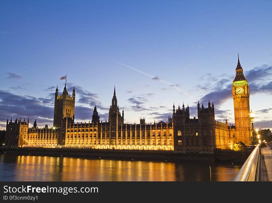 Parliament Building and Big Ben clock tower illuminated at night reflecting in Thames River, London, England. Parliament Building and Big Ben clock tower illuminated at night reflecting in Thames River, London, England.