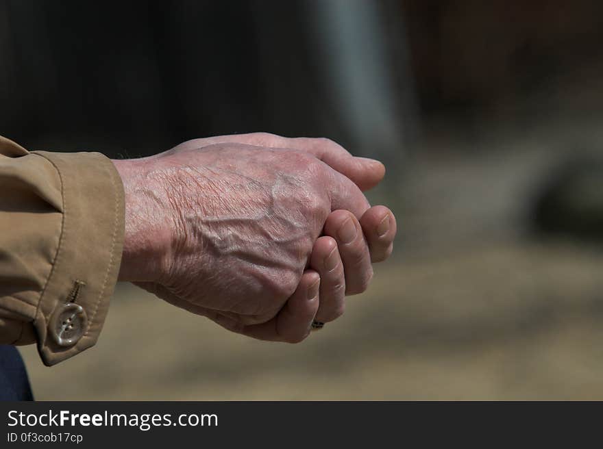 Man in Brown Dress Shirt Clasp Both Hands