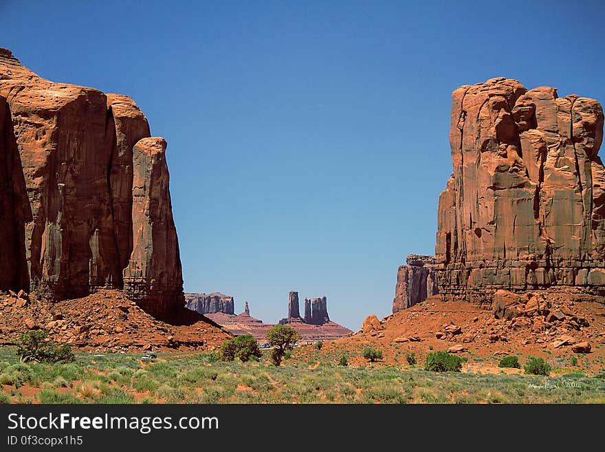 Sandstone rock formations in desert landscape on sunny day with blue skies.