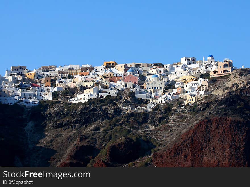 City on the mountainous coastline of Santorini island in Greece. City on the mountainous coastline of Santorini island in Greece.