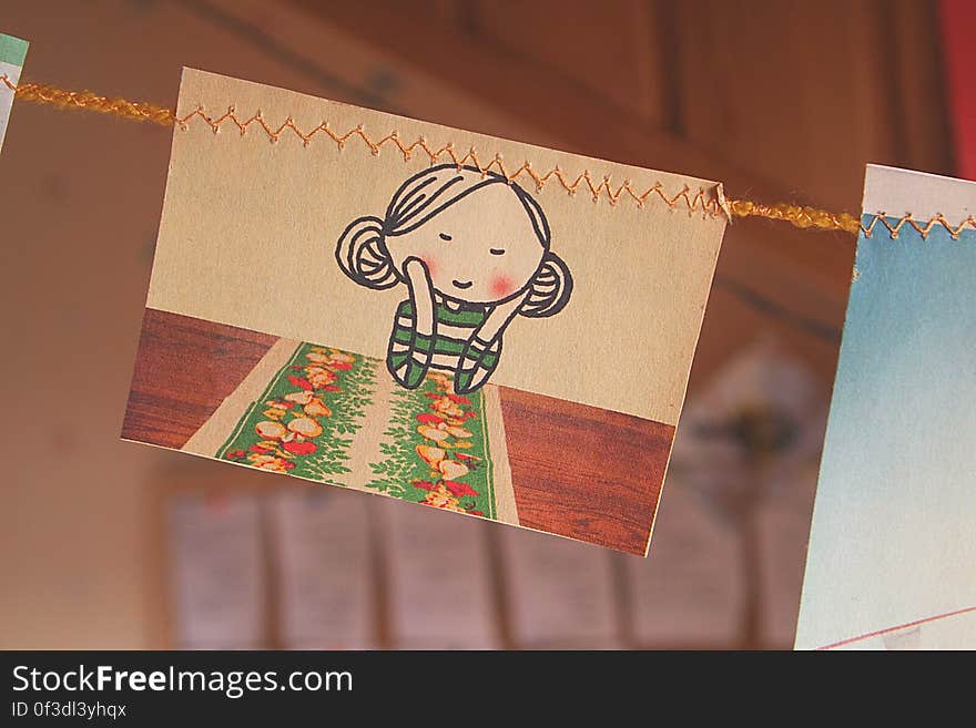 A drawing of a girl leaning on his hands hanging from a line. A drawing of a girl leaning on his hands hanging from a line.