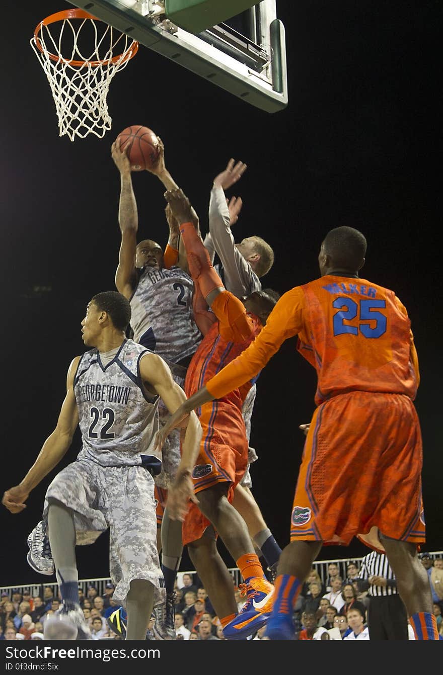 A game of basketball with the Florida Gators playing against Georgetown Hoyas. A game of basketball with the Florida Gators playing against Georgetown Hoyas.