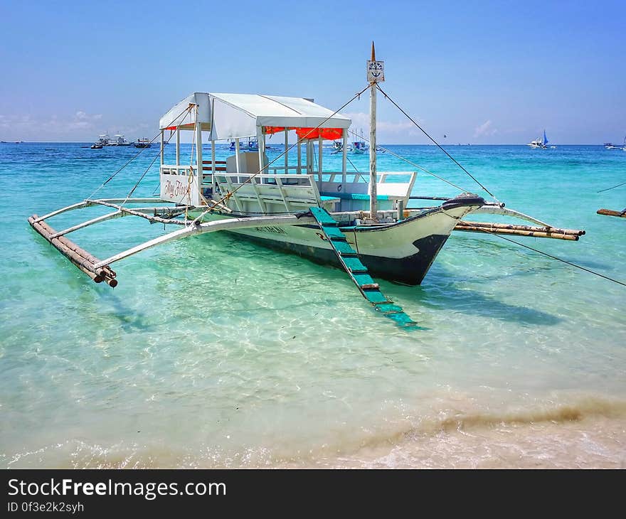 A traditional Asian trimaran boat on the shore. A traditional Asian trimaran boat on the shore.